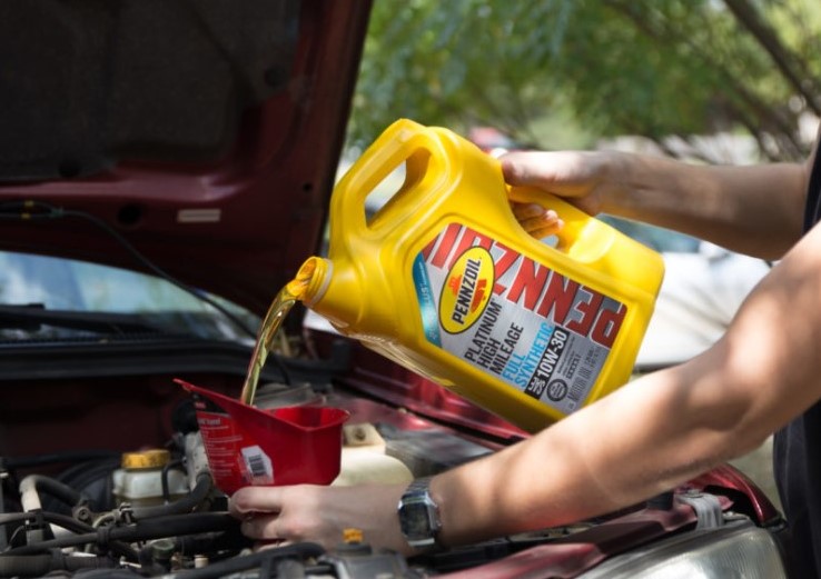 Close-up of the oil filler cap on the vehicle's engine.