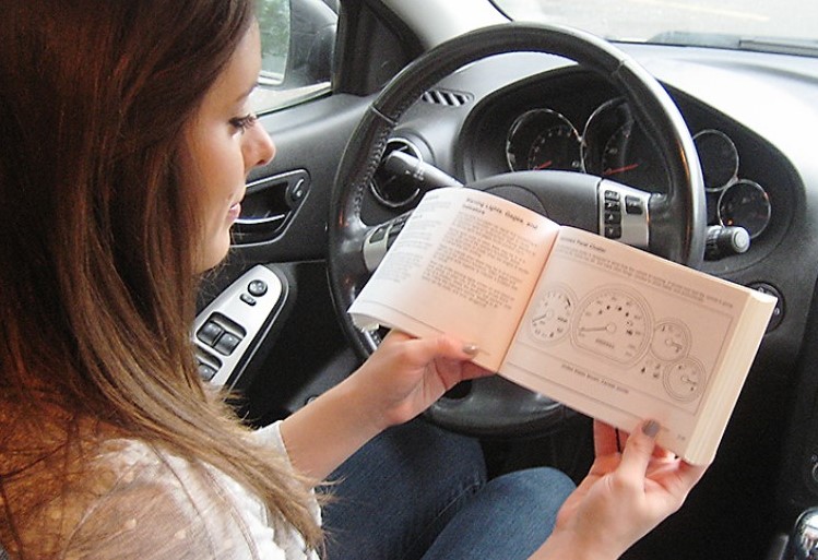 Open vehicle owner's manual showing oil specifications.